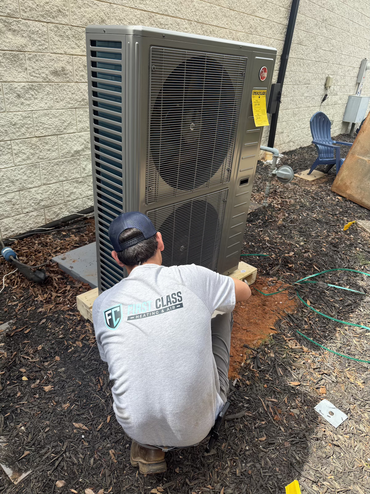 Cameron installing a Rheem heat pump condenser at commercial property