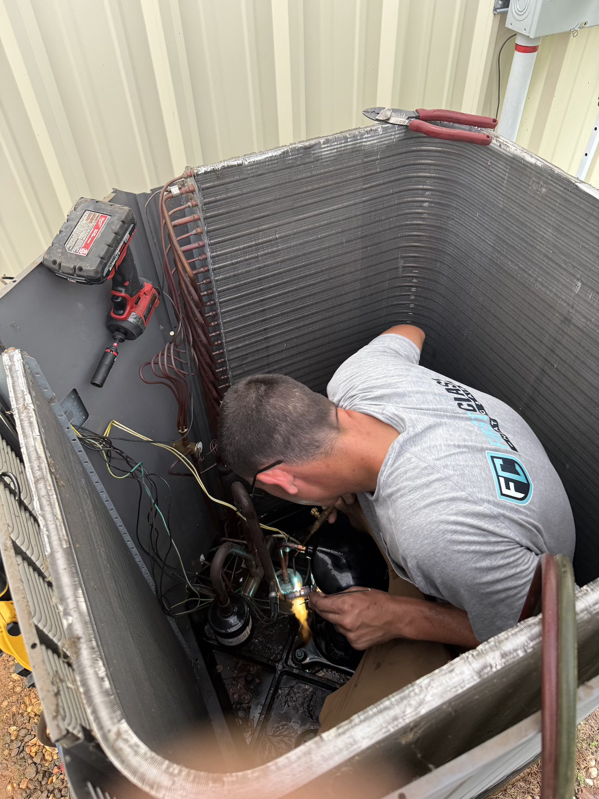 Soldering copper lines during a compressor replacement in Greenville, SC