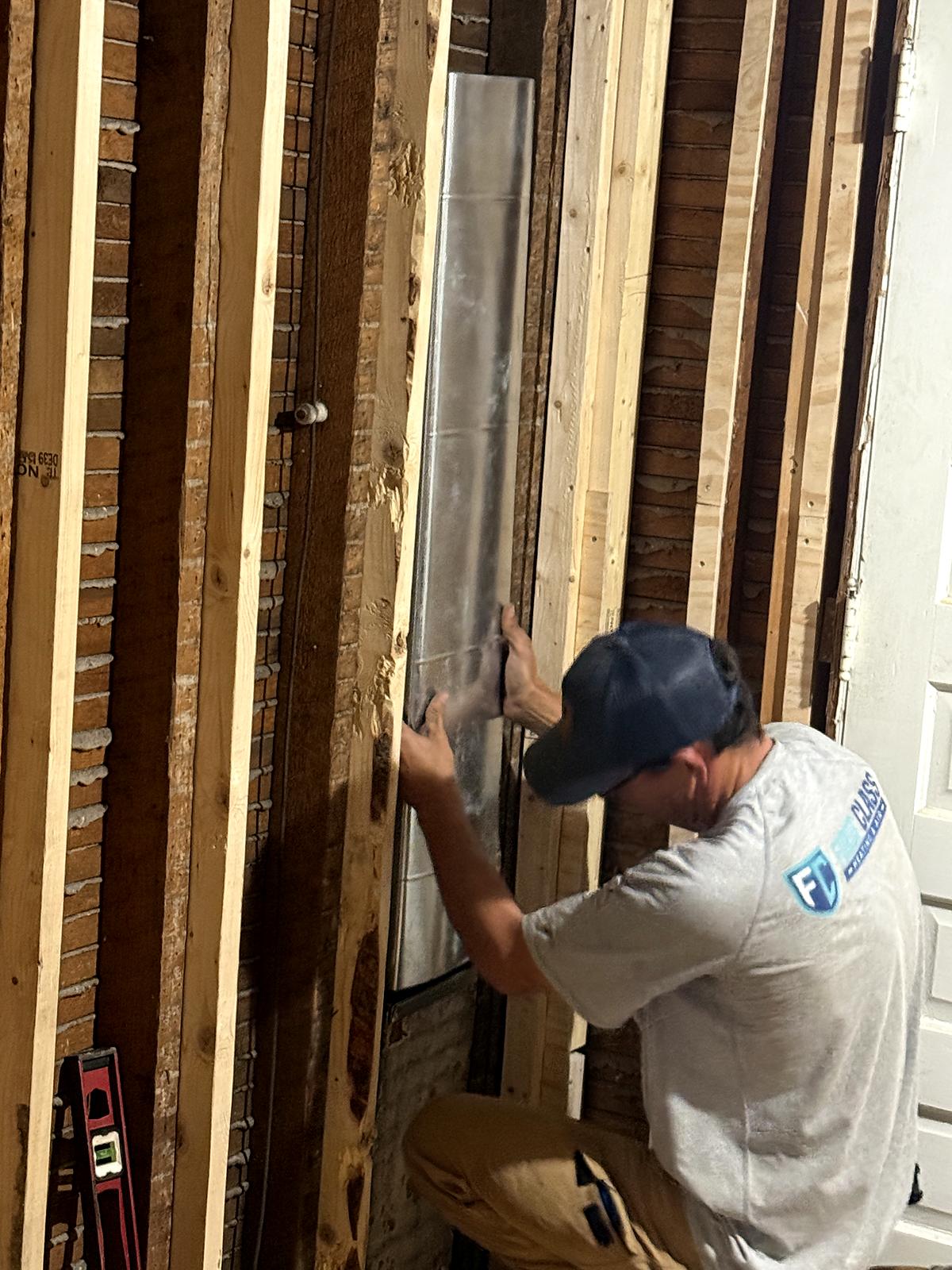 First Class technician fitting a custom sheet metal trunk line in Spartanburg, SC