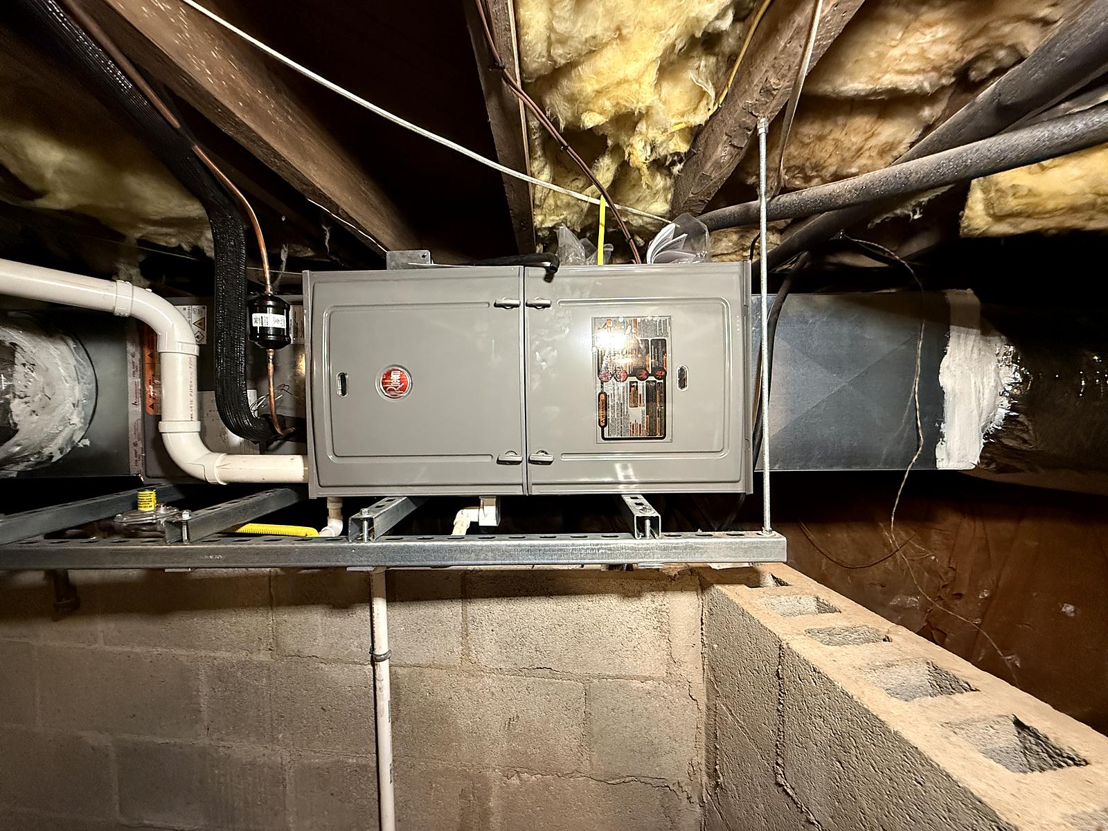 Rheem furnace replacement mounted on a rack in a crawl space on Augusta Road, Greenville, SC