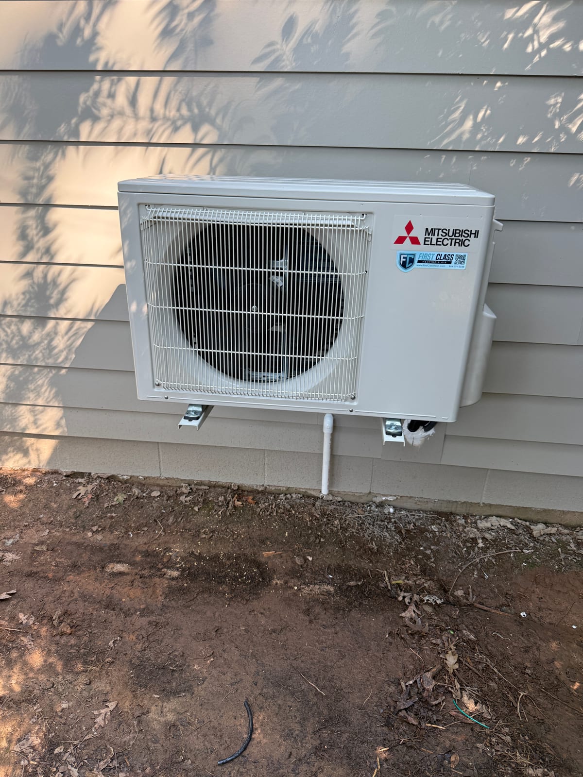 Mitsubishi Electric ductless mini split outdoor condenser wall-mounted on brackets beside a home in Upstate South Carolina