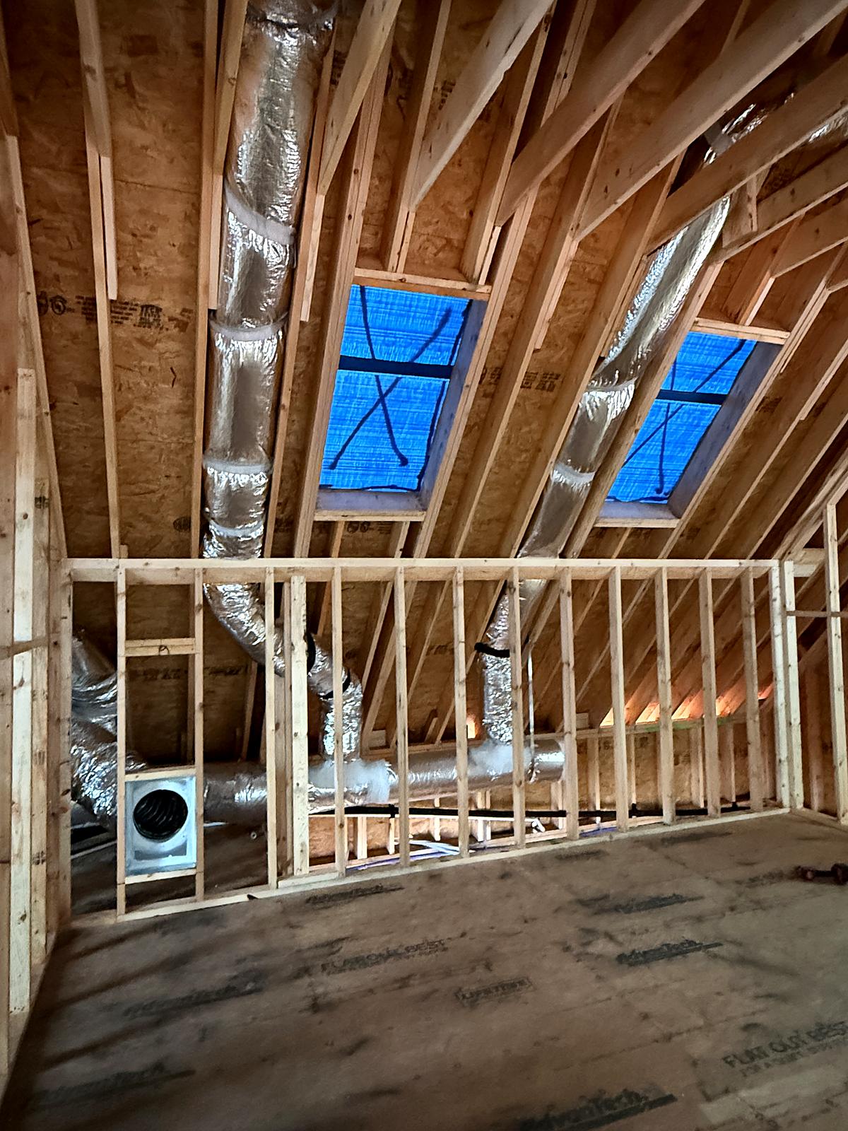 Insulated HVAC ductwork rough-in through open framing at a new construction home