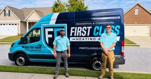 First Class Heating & Air technicians standing with the branded service van in a Greenville, SC neighborhood